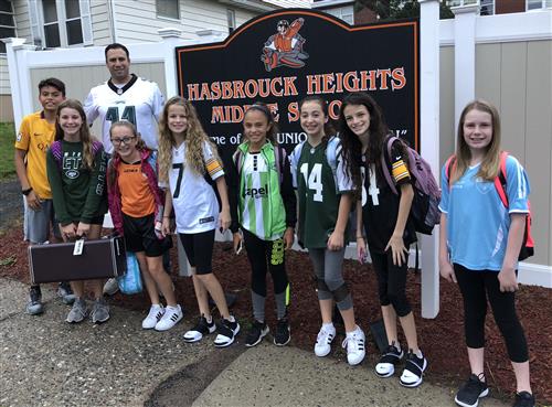 students and principal in front of middle school sign students and principal in front of middle school sign